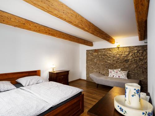 a bedroom with a bed and a couch at Płonica 1 in Złoty Stok
