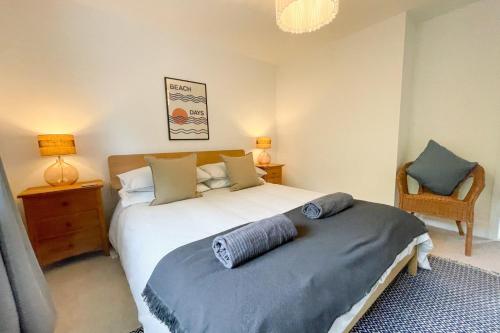 a bedroom with a bed and a chair in it at Sole Bay Croyde in Croyde