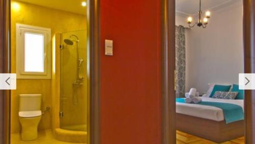 een kamer met een badkamer met een douche en een bed bij Cosy Colorful House in Kavala