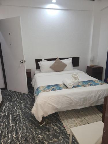a bedroom with a bed with two towels on it at Sunvilla beachfront hotel in Boracay