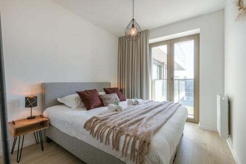 Ένα ή περισσότερα κρεβάτια σε δωμάτιο στο Huswell - Modern apartment with south facing terrace