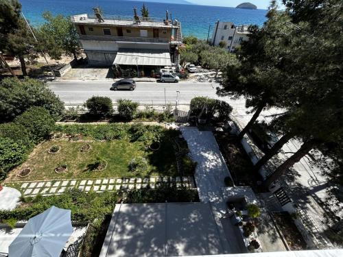 an overhead view of a park with a building and the ocean at Sunrise and Sunset Palio Sea View Appartment in Kavala