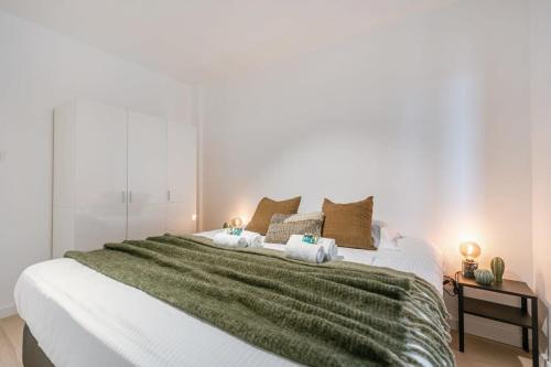 1 cama blanca grande con 2 toallas en Centrally located apartment in Middelkerke, en Middelkerke