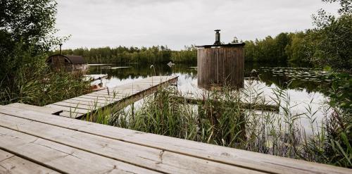 a dock in the middle of a body of water at Ödevata Gårdshotell in Emmaboda
