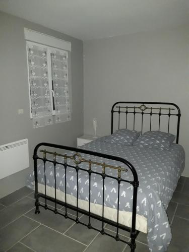 a bedroom with a bed and a window at Ancien moulin à eau en pleine nature 