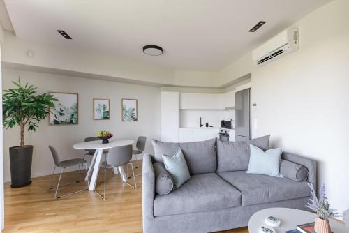 a living room with a couch and a table at Urban APT with Stunning Acropolis View & Roofdeck in Athens