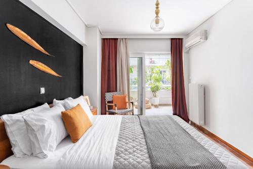 Schlafzimmer mit einem großen Bett mit einem schwarzen Kopfteil in der Unterkunft Fresh Detailed Stylish Apartment at Acropolis in Athen
