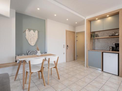 a kitchen and dining room with a table and chairs at Alexia Beach Hotel in Agia Marina Nea Kydonias
