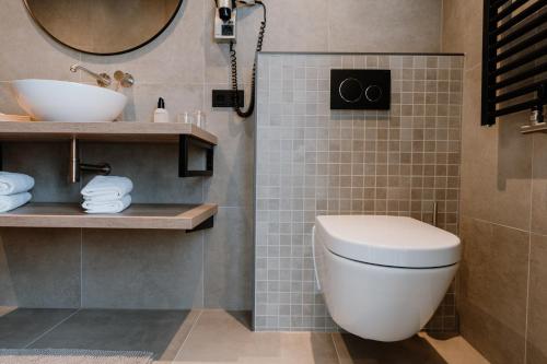 a bathroom with a toilet and a sink at Kodde Studio in Aagtekerke