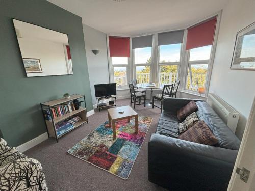 a living room with a couch and a table at Seabreeze Apartment in Eastbourne