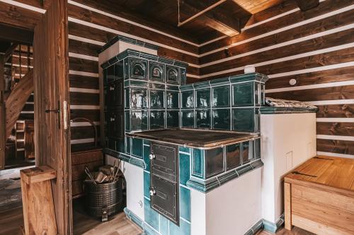 a kitchen with green glass cabinets and a stove at Roubenka50 in Jičín