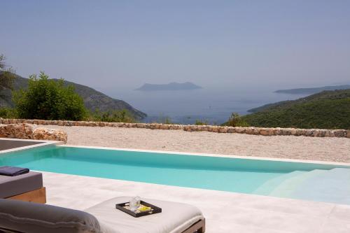 a swimming pool with a view of the ocean at Armante Supreme Villas - Villa Ilianna in Fternón