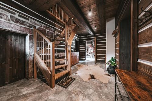 a staircase in a room with wooden walls at Roubenka50 in Jičín