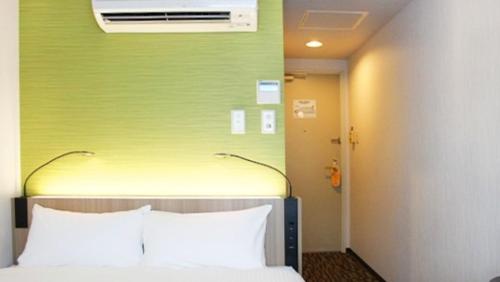 Ένα ή περισσότερα κρεβάτια σε δωμάτιο στο Smile Hotel Tokyo Asagaya
