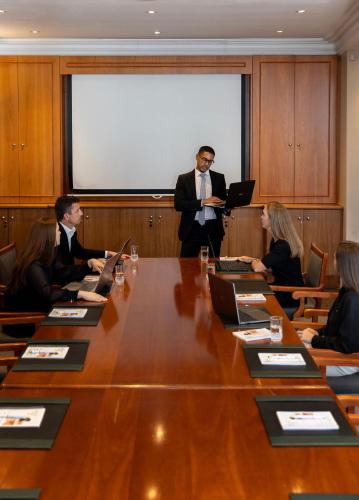 a group of people sitting around a table in a conference room at Lemoenkloof Boutique Hotel in Paarl
