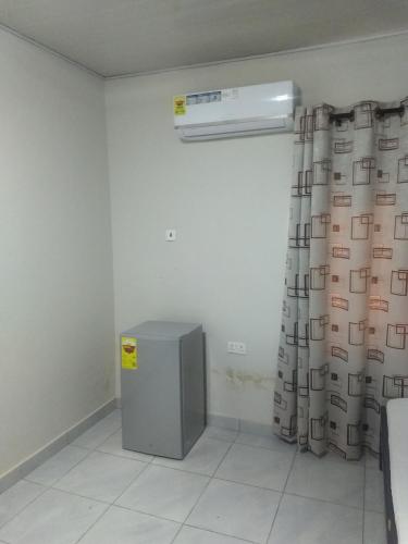 a room with a heater and a shower curtain at TwoSix24 Guest house in Kasi