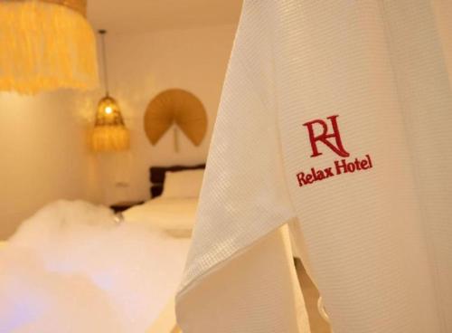 a hotel room with a white curtain with the rishi hotel on it at Foga Hebrus in Ksamil