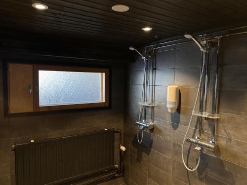 a bathroom with a shower and a window at Enonkosken Kartano & Guesthouse in Enonkoski