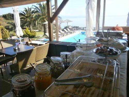 a table with a tray of food next to a pool at Barbagiannis House in Ormos Panagias