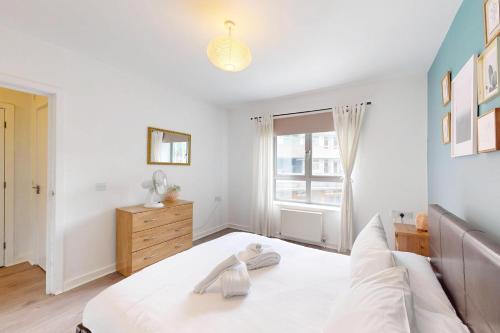 a bedroom with a white bed and a window at Modern 1 BD Apartment in London - 5 min to Station in London
