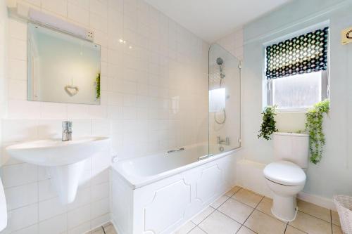 a white bathroom with a sink and a toilet at Modern 1 BD Apartment in London - 5 min to Station in London