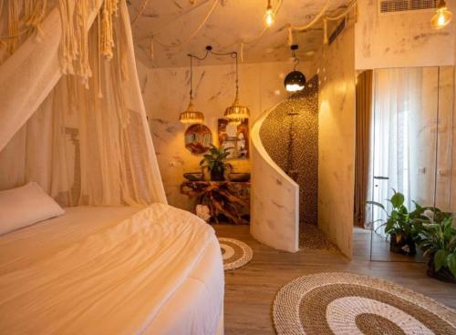 a bedroom with a bed and a staircase in it at Foga Hebrus in Ksamil