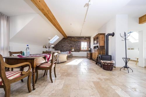a large living room with a table and chairs at Hofgut Dösterhof - Ferienwohnungen in Wadern