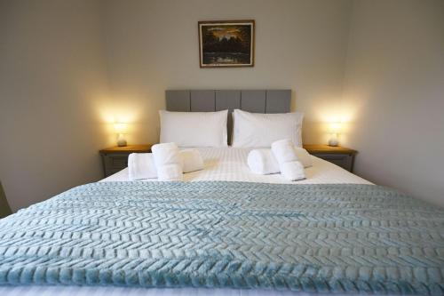 a bedroom with a large bed with two lamps at Avoca Lodge in Fort William