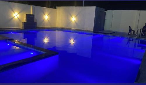 a swimming pool with blue lights in a room at The King Palace and Resort in Udaipur