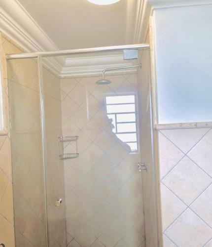 a shower with a glass door in a bathroom at Classic Loft in Pretoria