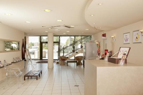 a lobby of a store with a counter and chairs at Cerise Valence in Valence