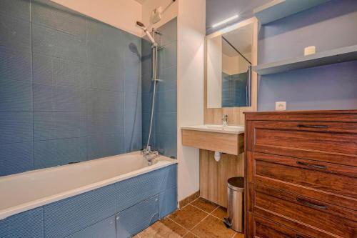 une salle de bain avec une baignoire et un lavabo dans l'établissement Appt T3 - 15min de Disneyland - Parking gratuit, à Bussy-Saint-Georges