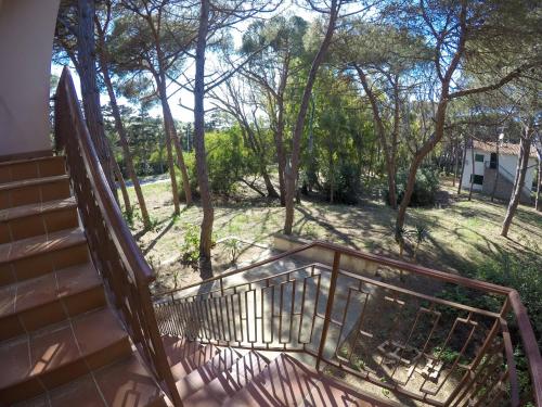 a staircase leading to a yard with trees at Strategic Home in Platamona