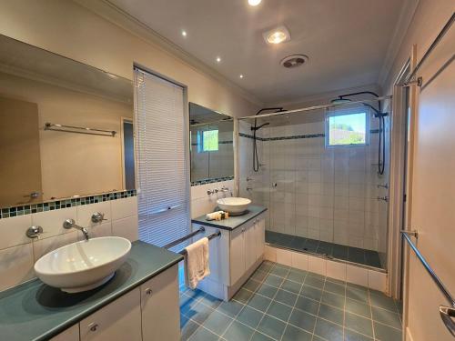 a bathroom with two sinks and a shower at Bussell Hideaway Haven in Broadwater