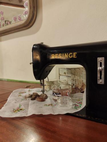 a sewing machine sitting on top of a table with cookies at La Spelonca degli Asini in Prata