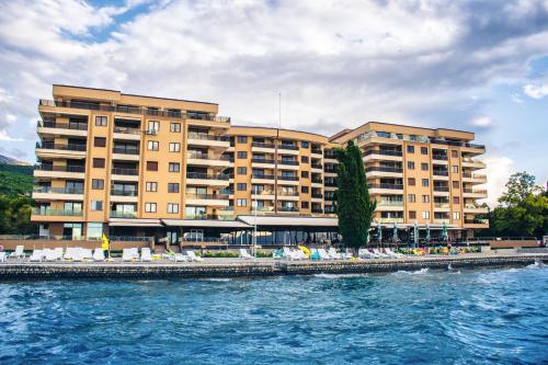 a large building next to a body of water at Park Lakeside Ohrid in Ohrid