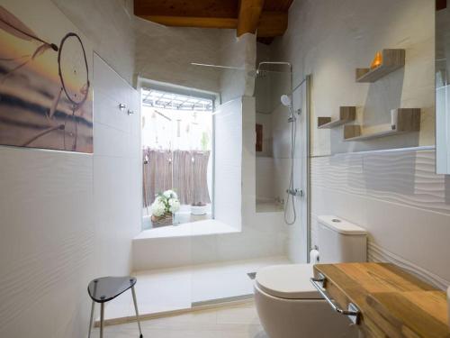 a bathroom with a toilet and a sink and a window at Modern Banana Plantation House with sea views and private pool in Arucas