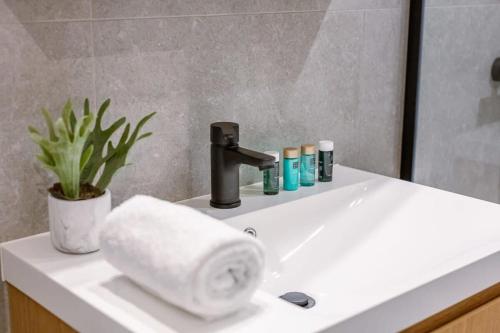 w łazience znajduje się umywalka z kranem i ręcznik. w obiekcie Bright family apartment with magnificent view w Ostendzie