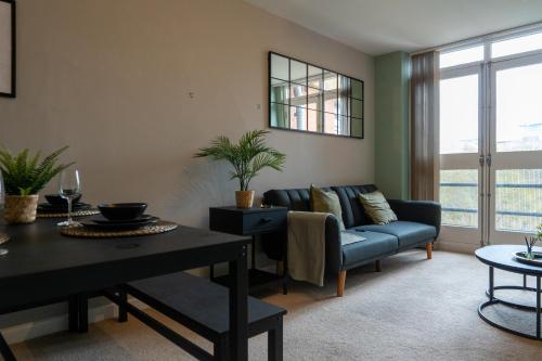 a living room with a couch and a table at City Centre - 2BR Apt - Free Parking - Long Stays in Nottingham