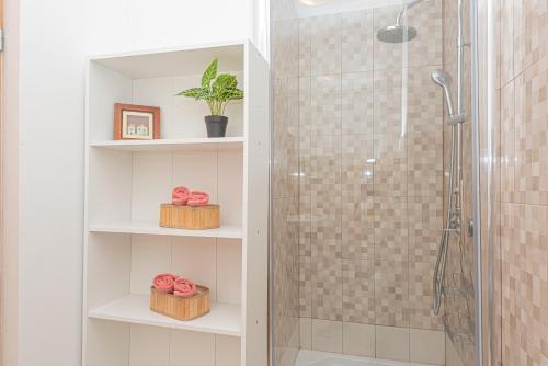 a bathroom with a shower with a glass shower stall at Holiday Home Family Fun in Grebaštica