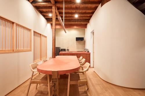 a dining room with a wooden table and chairs at anchorAsakusa Vacation Rental in Tokyo