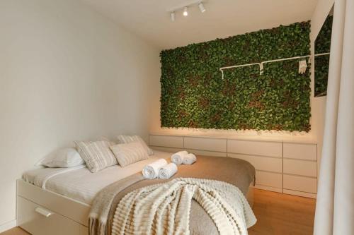 a bedroom with a bed with two towels on it at Huswell - Beautiful apartment in the heart of Antwerp in Antwerp