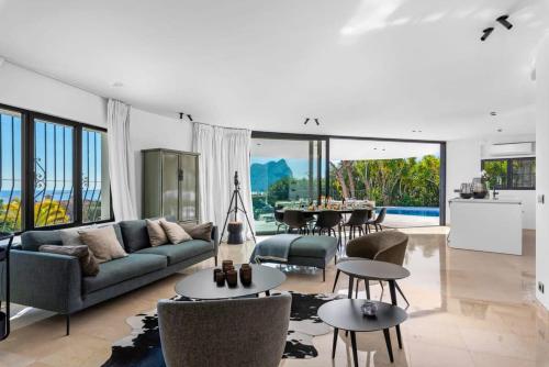 a living room with a couch and a table at Huswell - Relax in luxury at this stunning seaside Villa in Calpe