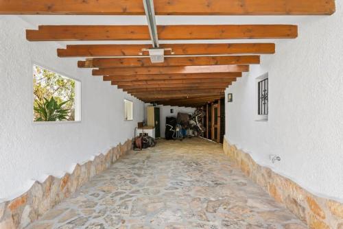 an empty hallway of a house with a wooden ceiling at Huswell - Relax in luxury at this stunning seaside Villa in Calpe