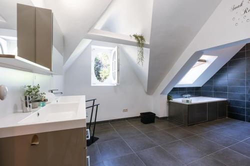 a kitchen with white counters and blue tiles at Great apartment in the heart of Ypres in Ieper