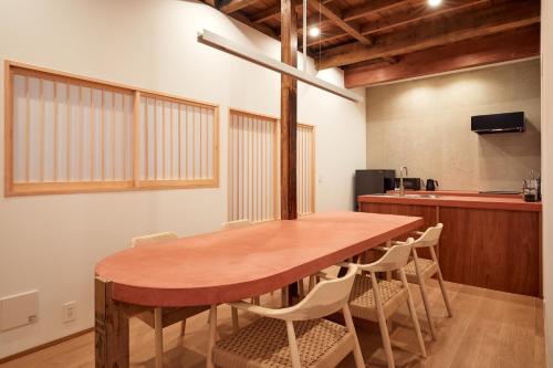 a dining room with a wooden table and chairs at anchorAsakusa Vacation Rental in Tokyo