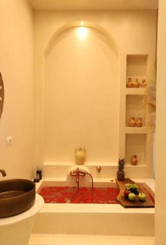 a bathroom with a bath tub with a sink at Foga Hebrus in Ksamil