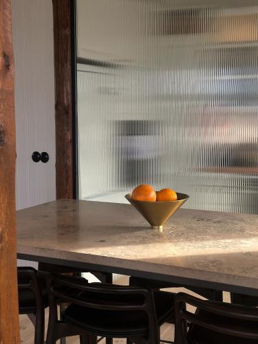 a bowl of oranges sitting on a table at Hótel Karólína in Stykkishólmur