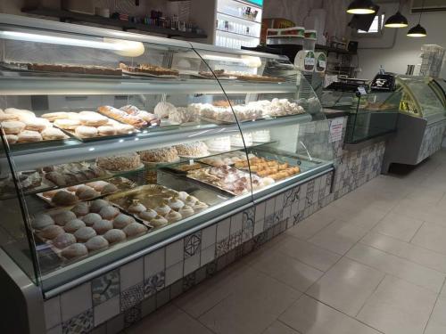 a bakery filled with lots of different types of donuts at Iris Gargano Vacanza in Peschici