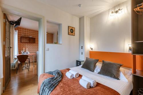 a bedroom with a large bed with towels on it at Characterful apartment for two in central Ghent in Ghent
